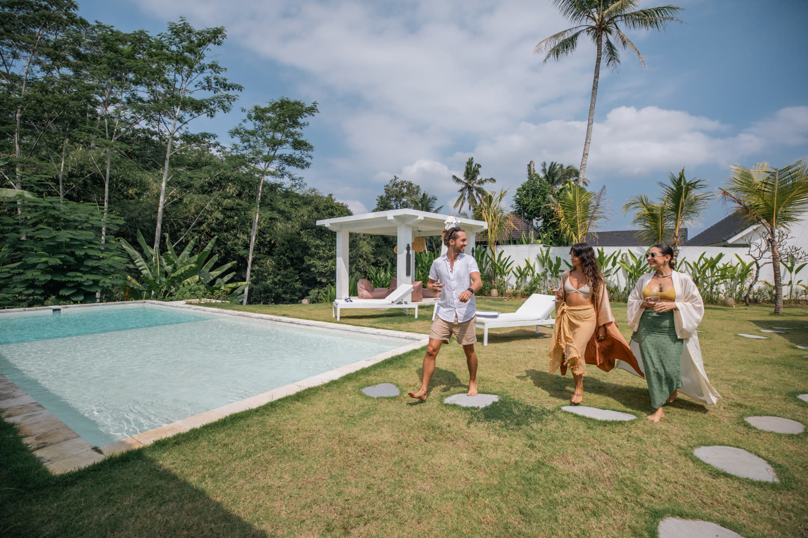 Guests by the pool at Bos Villas Bali