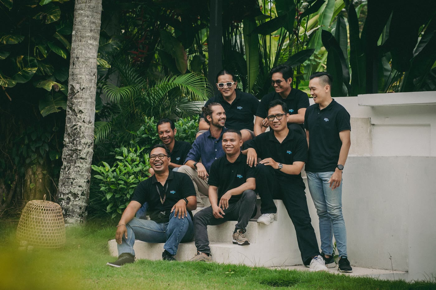 A team gathered in the villa garden during a corporate retreat
